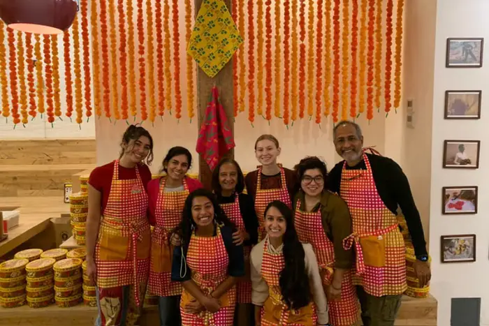 A group of people standing together in matching aprons.